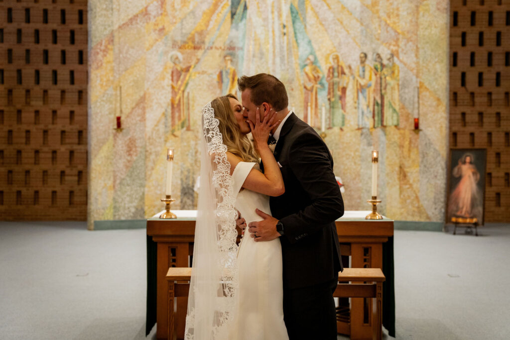 Newlyweds sharing first kiss as husband and wife.