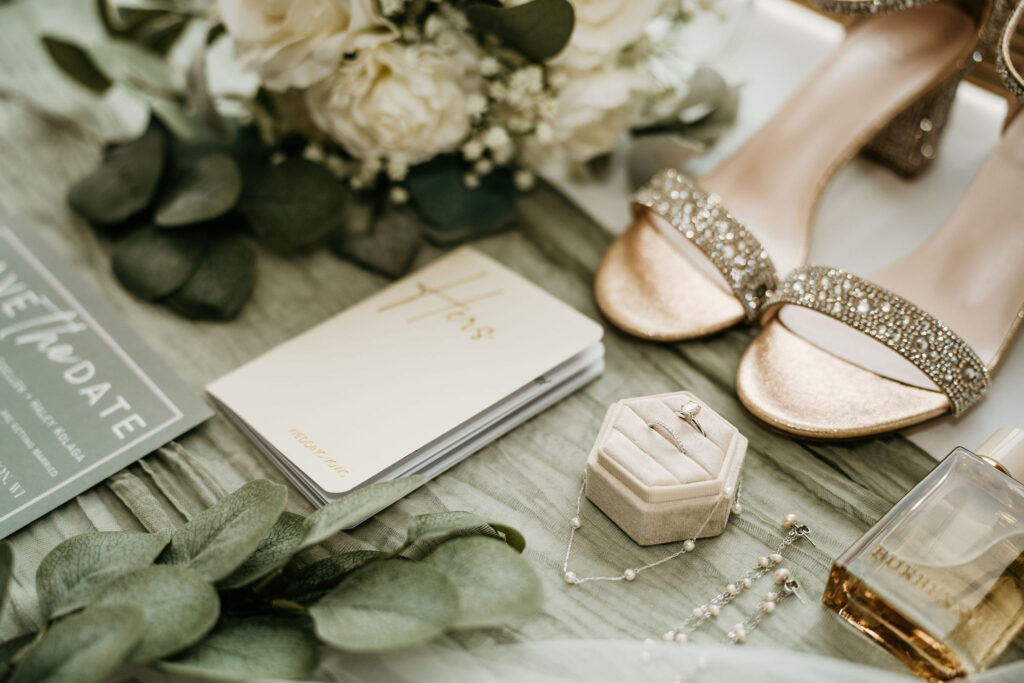 Close-up of wedding rings on invitation card.