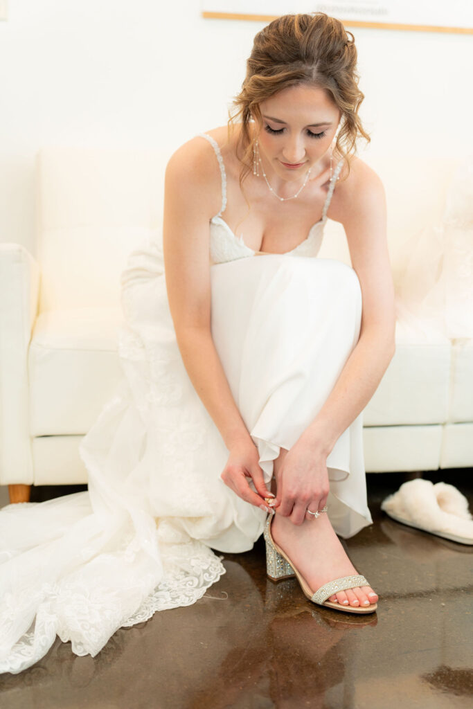 Bride adjusting veil before wedding ceremony.